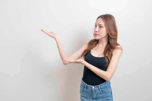 portrait beautiful woman with hand presenting or pointing photo