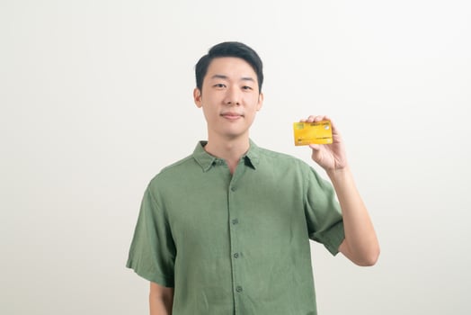 young Asian man holding credit card photo
