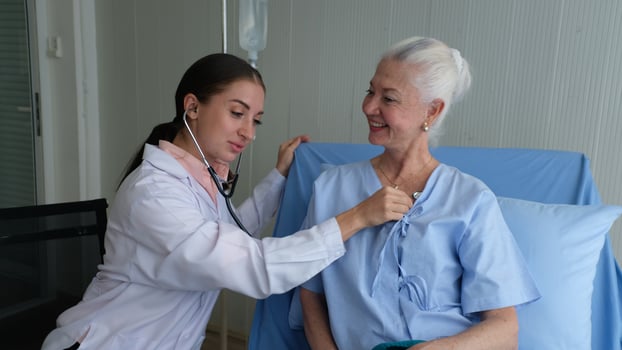 Female doctor and elderly patient check up in hospital. photo