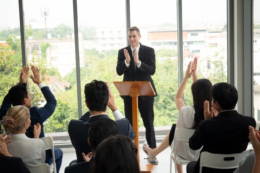 Group of people listening to experienced business professional helping them work out new corporate strategy. photo