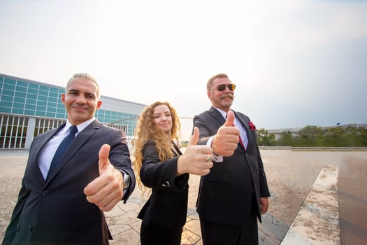 Successful business people standing together widen out showing strong relationship of worker community. A team of businessman and businesswoman expressing a strong group teamwork at the modern office. photo