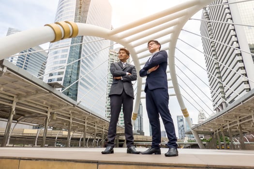 Successful business people standing together widen out showing strong relationship of worker community. A team of businessman and businesswoman expressing a strong group teamwork at the modern office. photo