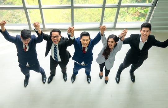 Successful business people standing together widen out showing strong relationship of worker community. A team of businessman and businesswoman expressing a strong group teamwork at the modern office. photo
