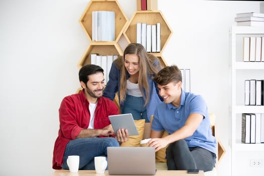 Diverse group of young business people discussing a work project while sitting together at a table in a modern office. coworking concept photo