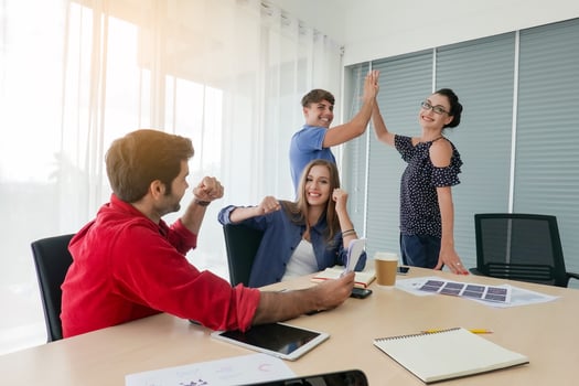 Diverse group of young business people discussing a work project while sitting together at a table in a modern office. coworking concept photo