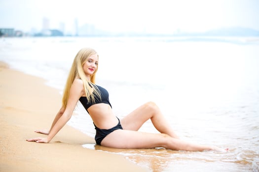 Beautiful blonde woman on black bikini enjoy summertime on the beach. photo