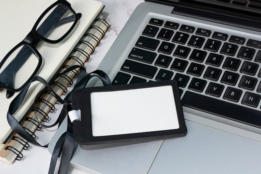 Black name tag placed on a laptop or notebook. Registration concept. photo