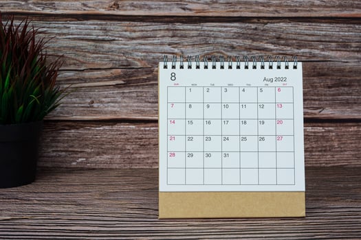 White August 2022 calendar on wooden desk. 2022 new year concept. photo