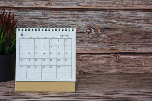White September 2022 calendar on wooden desk. 2022 new year concept. photo