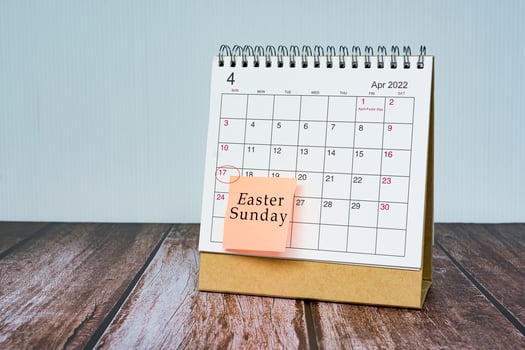 April calendar with date 17th circle and Easter Sunday text on sticky note. photo