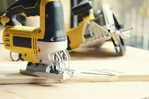 Electric Jigsaw on Walnut Plywood , jigsaw tool for bevel cuts in wood boards and other materials. photo