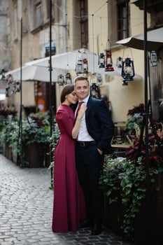 Young couple in a candid shot. They are walking in the street. photo