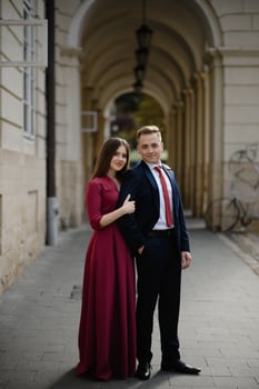 Young couple in a candid shot. They are walking in the street. photo