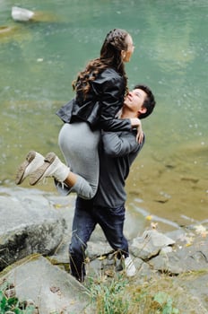 incredibly beautiful and lovely couple on the background of a mountain river photo