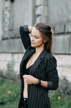 Young attractive cheerful woman walking in city. photo