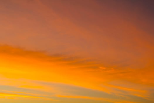 The sky is a horizontal line of yellow-orange and colorful colors in the beautiful evening in the midst of nature which is peaceful, warm and romantic in the countryside and is extremely beautiful. photo