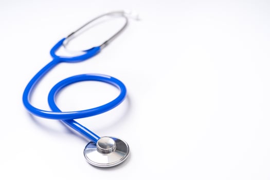 Blue stethoscope,object of doctor equipment for heartbeat trace,isolated on white background. Medical design concept,close up and studio shot. photo