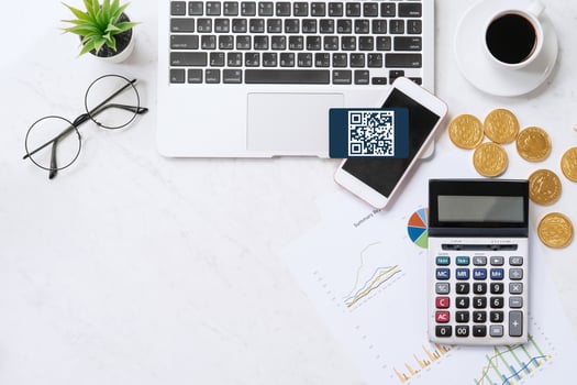 Online payment with QR code concept, virtual credit card, smart phone on office laptop desk on clean marble table background, top view, flat lay photo