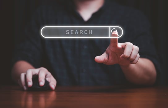 Hand touching to virtual search icon to SEO or search Engine Optimisation for marketing and consumer information concept. photo