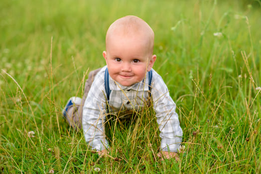 Father and mother lead their one-year-old son by the hand. photo