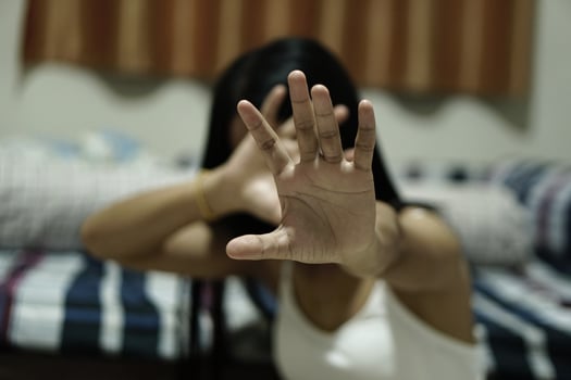 Woman raised her hand for dissuade, campaign stop violence against women , hand focus, vintage tone photo
