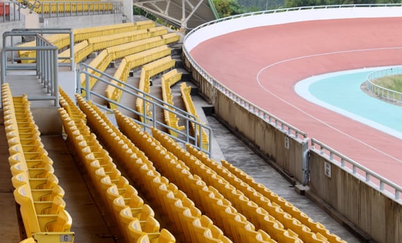 Yellow seats on stadium grandstand in cycling photo