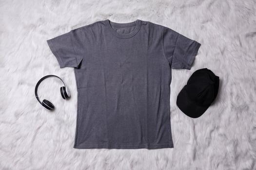 Grey t-shirt mockup with man accessories on grey background. Flat lay tee template photo