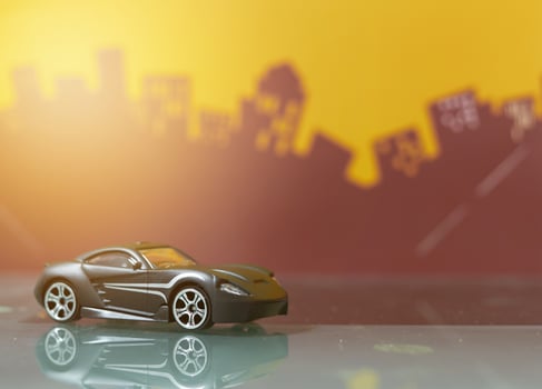 Black Sport car toy selective focus on blur city background photo