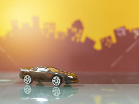 Black Sport racer car toy selective focus on blur city background photo