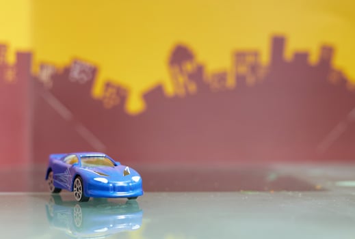 blue Saloon car toy selective focus on blur city background photo