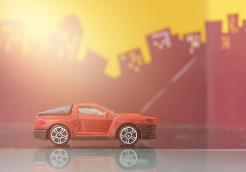 red mini truck or pick up car toy selective focus on blur city background photo