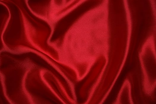 Red cloth waves background texture. photo
