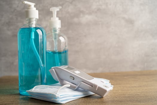 Blue alcohol sanitizer gel with digital thermometer and mask for new normal protect covid19 coronavirus pandemic. photo