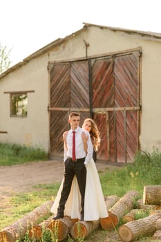 Bride and groom in a wheat field. The couple hugs during sunset photo