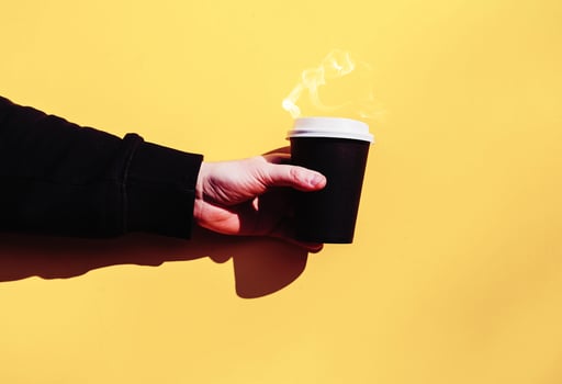 hand holding paper mug photo