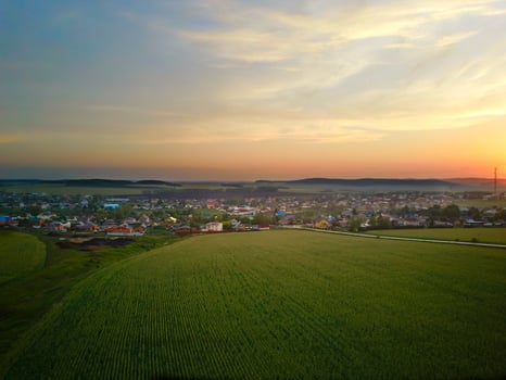 A bird's-eye view from a drone of the countryside landscape. Agricultural fields, villages and woodlands. photo