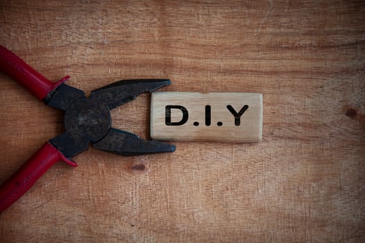 Text on wooden block - D.I.Y with working tool background. photo