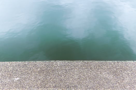 Pebble stone textured floor beside the river. The pattern floor show as seamless background. photo