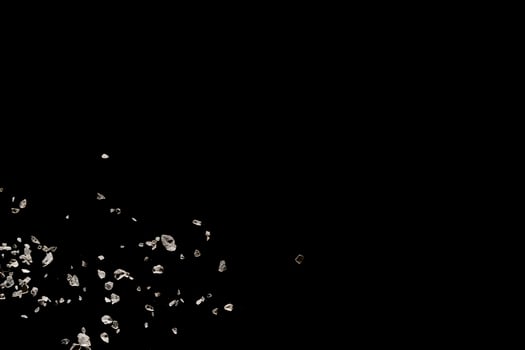 Split debris of stone exploding against black background. photo