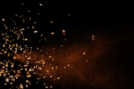 Split debris of stone exploding against black background. photo