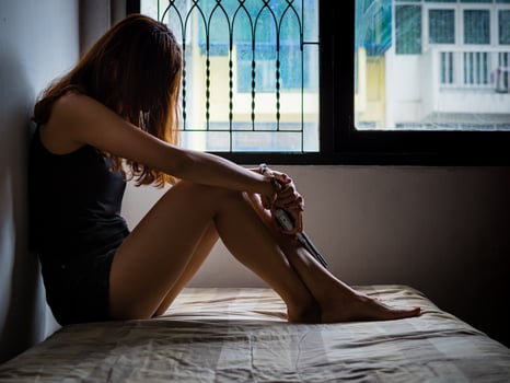 Young women who are stressed from using drugs are handcuffed photo