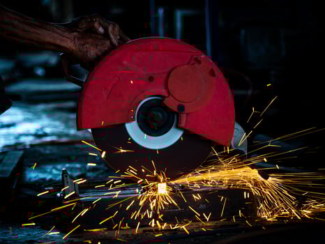 Professional technicians in the factory are using power tools to cut the metal photo