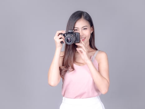 Beautiful and charming women dressed in casual style, carrying film cameras photo