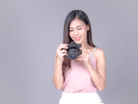 Beautiful and charming women dressed in casual style, carrying film cameras photo