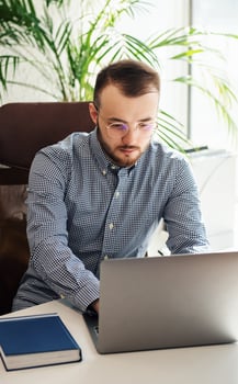 Businessman working on his laptop in an office photo