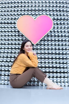 Asian beautiful woman with long hair is sitting and smiling in heart background as Valentine s  day concept. abstract background photo