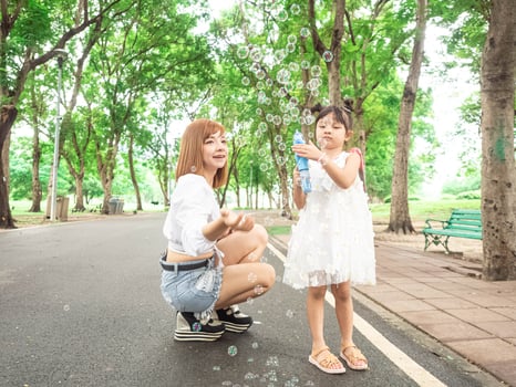 Outdoor nature park green public road holiday family parent mother baby child kid portrait beauty hug cuddle fold love blow bubble picnic funny lifestyle happy valentine business romance together photo