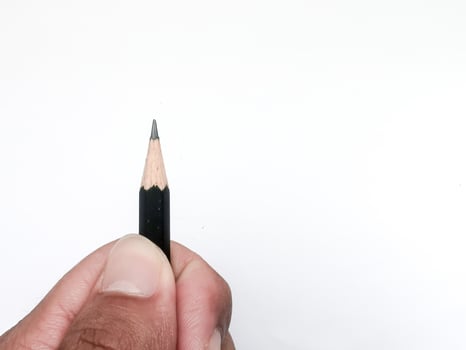 hand holding a black pencil ready to write something on paper photo