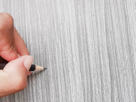 hand holding a pencil writing photo