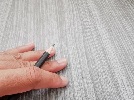 hand holding a pencil writing photo